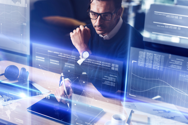 Businessman analysing the data on futuristic screen