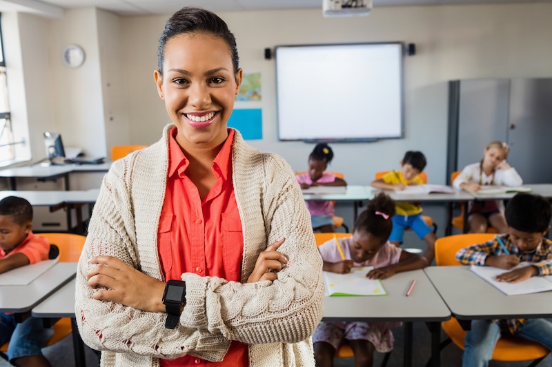 Portrait of smiling teacher deskless worker frontline worker